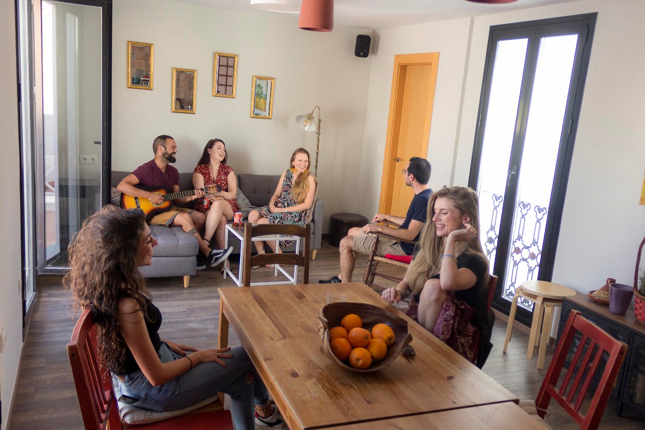 Guests on rooftop common area 2 Hostel people having fun in rooftop dining room