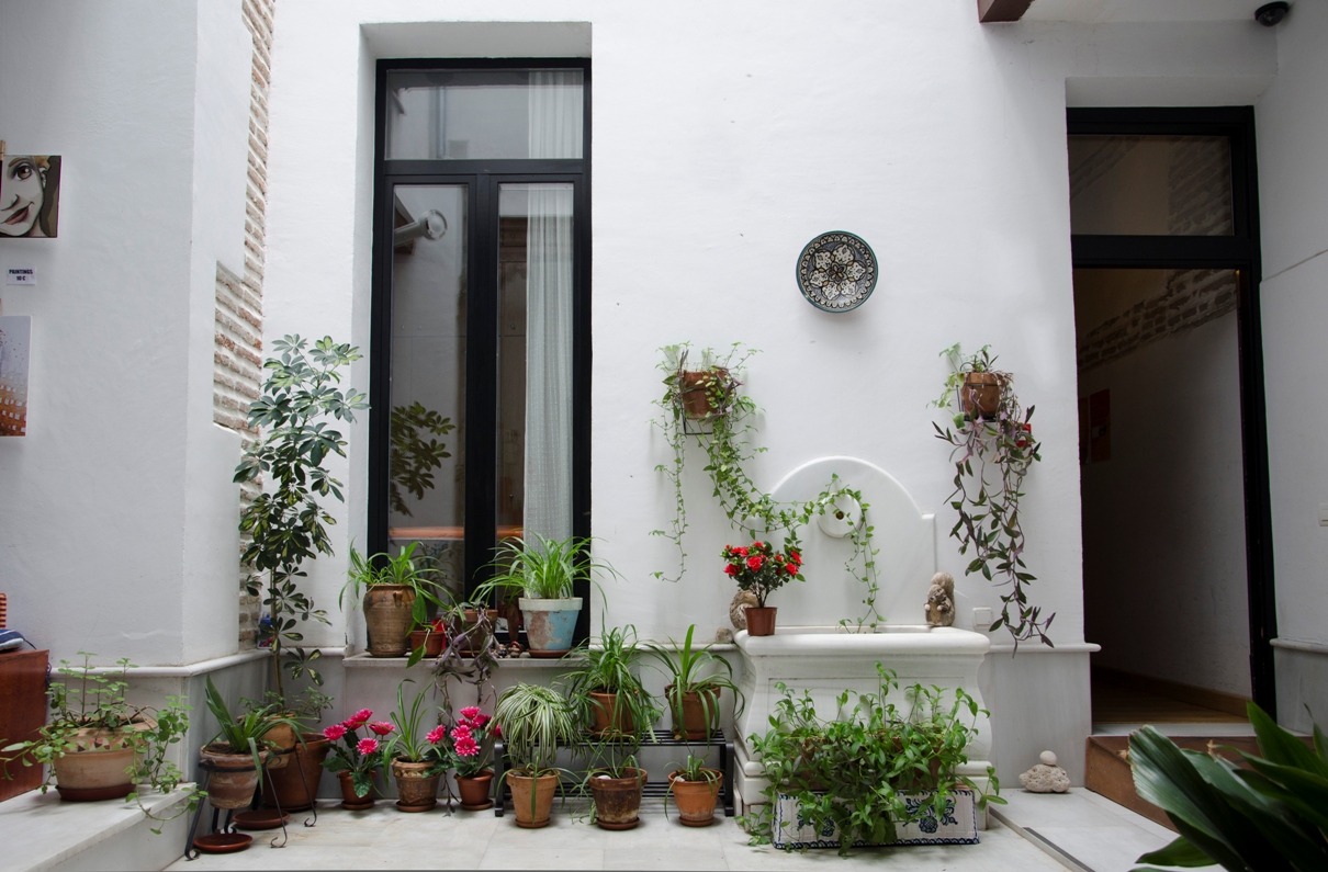 Main patio Typical Andalusian patio of el granado hostel, with plants and a fountain